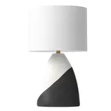 A modern table lamp with a white cylindrical shade and a two-toned base featuring white and dark gray angled sections.
