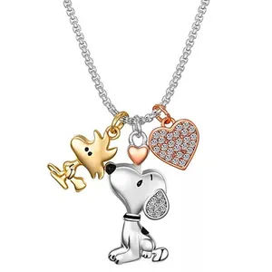 A necklace with charms depicting a cartoon dog and bird, accompanied by a heart embellished with small stones. The chain and charms are in mixed metals, including gold, silver, and rose gold tones.
