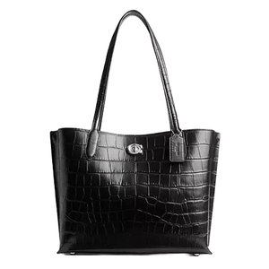 The Coach Willow Tote in black features a crocodile-embossed pattern with two shoulder straps and a central turn-lock closure, offering a stylish and functional handbag option.
