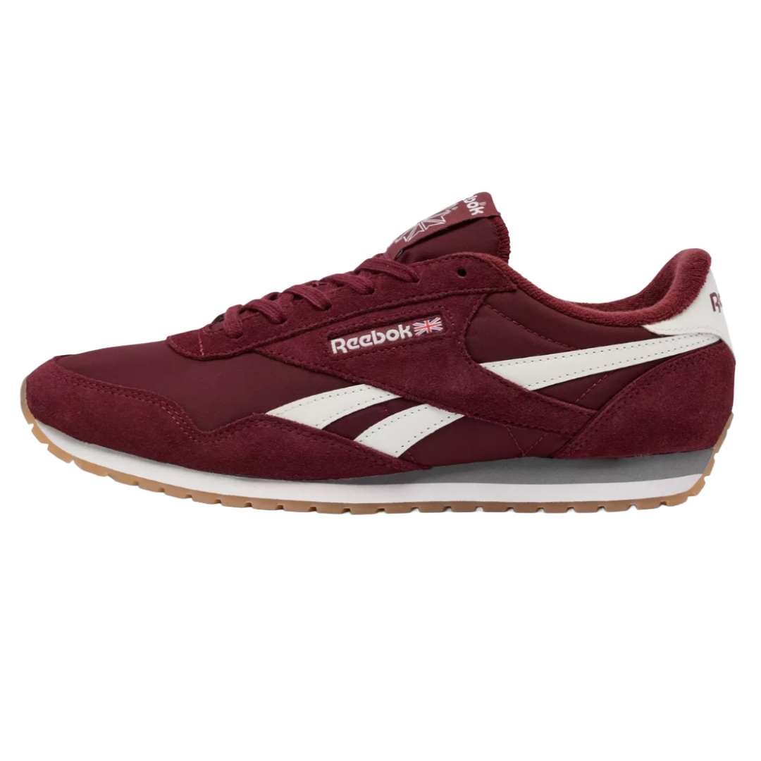 Maroon Reebok sneaker with white accents, featuring the Reebok logo and a Union Jack flag. The shoe has a gum sole and suede overlays.