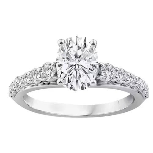 A diamond engagement ring featuring an oval-cut center stone in a prong setting with additional round diamonds embedded along the band.