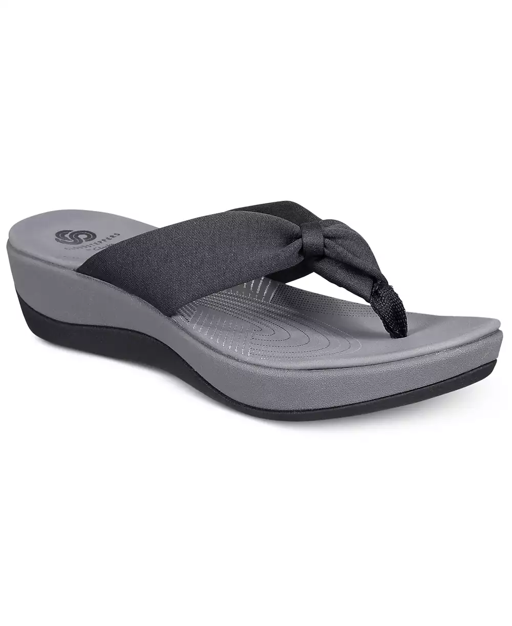 Black wedge flip-flop with a soft fabric strap tied in a knot over the top.
