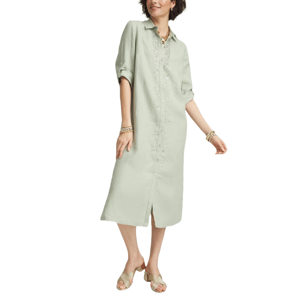 A light green linen midi shirt dress with subtle embellishments on the front, featuring a collared neckline and button-down closure. The dress has rolled-up sleeves and a front slit, paired with heeled sandals and gold jewelry.
