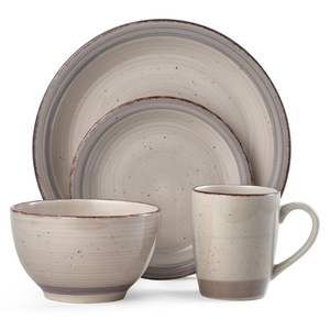 A four-piece stoneware dinnerware set featuring a bowl, mug, dinner plate, and salad plate, each with a textured beige finish and subtle speckled design.