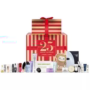 Macy's 25 Days of Beauty Advent Calendar features a variety of skincare and beauty products, including creams, masks, serums, and beauty accessories, presented in a red and gold striped gift box.
