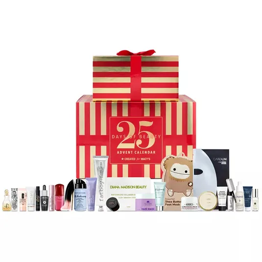 Macy's 25 Days of Beauty Advent Calendar features a variety of skincare and beauty products, including creams, masks, serums, and beauty accessories, presented in a red and gold striped gift box.