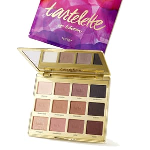 Tartelette In Bloom eyeshadow palette by Tarte, featuring 12 shades in matte and shimmer finishes, encased in a purple and pink floral compact with a mirror.