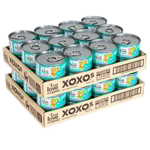 A 48-pack of grain-free wet cat food cans, with \“XOXOS\“ and \“I and love and you\“ branding, is displayed in stacks.