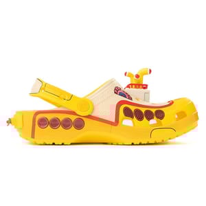 A yellow and cream shoe designed like a submarine, featuring multiple circular window-like designs, a periscope, and an adjustable strap.