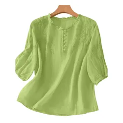 Light green blouse with floral embroidery, round neck, three-quarter sleeves, and button details on the front.
