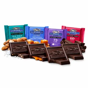 Assorted Ghirardelli chocolates, including Intense Dark Sea Salt, 72% Cacao, Sea Salt Caramel, and 60% Cacao. Surrounded by almonds, caramel, sea salt, and chocolate curls.