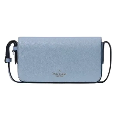 A light blue Kate Spade crossbody bag with a pebbled leather texture, featuring a compact design and a simple strap.