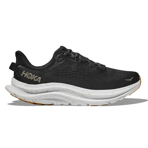 Hoka Women's Kawana 2 Shoes feature a black upper with a breathable design, white midsole, and gum-colored outsole, offering a balance of comfort and performance for running or casual wear.