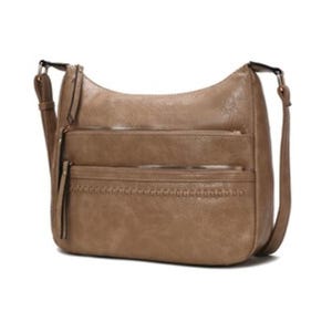 A taupe crossbody handbag with an adjustable strap and multiple zippered compartments on the front.