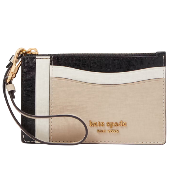 Kate Spade wristlet with color-block design in black, cream, and beige, featuring multiple card slots, a gold-tone logo, and a detachable wrist strap.