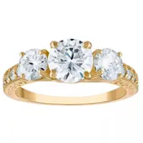 Gold ring featuring three large round diamonds with a detailed band.