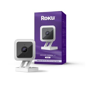 Roku Indoor Camera SE is a wired indoor camera with a sleek design featuring a square shape, white body, and black face. It's packaged in a purple box, emphasizing its function to monitor any room in your home.