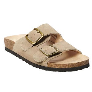 A beige sandal featuring two adjustable straps with brass buckles, a cork footbed, and a black rubber sole.