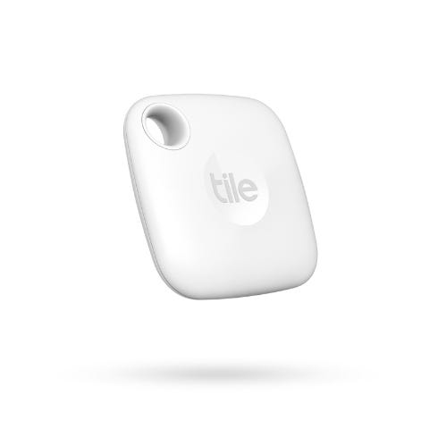 A square, white Tile Mate tracker with a rounded design and a hole in one corner for easy attachment to keys or bags, featuring the Tile logo on its surface.