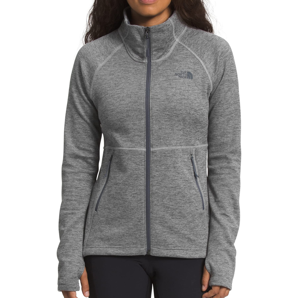 A gray full-zip jacket with a high collar, featuring The North Face logo on the chest and two zippered side pockets.