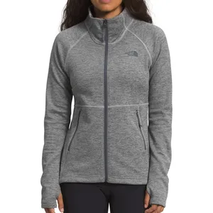 A gray full-zip jacket with a high collar, featuring The North Face logo on the chest and two zippered side pockets.