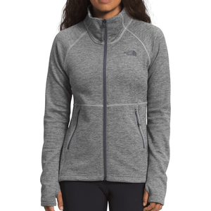 A gray full-zip jacket with a high collar, featuring The North Face logo on the chest and two zippered side pockets.