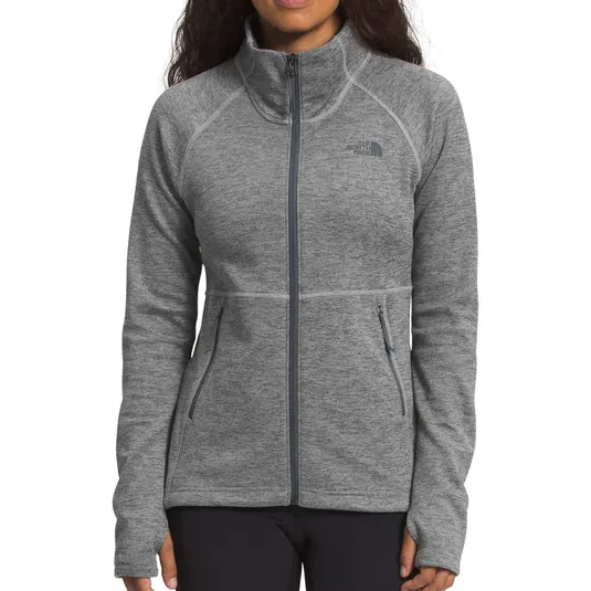 A gray full-zip jacket with a high collar, featuring The North Face logo on the chest and two zippered side pockets.