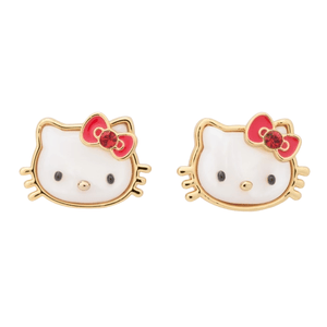 Gold-tone Hello Kitty stud earrings featuring her iconic face with a white enamel finish, black eyes and nose, and a red bow adorned with a small gem on her left ear.