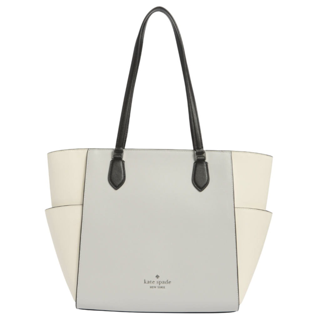 A Kate Spade New York tote bag with a two-tone design of light gray and cream, featuring black handles and embossed branding on the front.