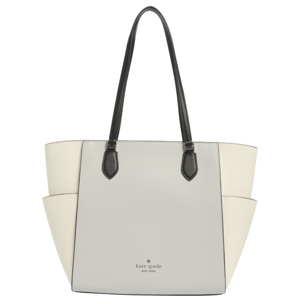 A Kate Spade New York tote bag with a two-tone design of light gray and cream, featuring black handles and embossed branding on the front.