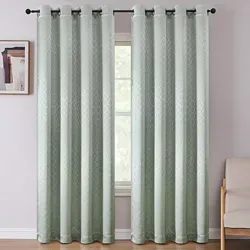 Light green curtains with a subtle geometric pattern hang on a black rod, partially covering a window. A small picture is on the wall, and a beige chair is visible to the right.