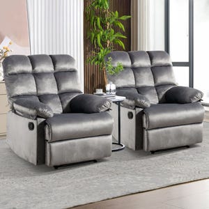 Two plush gray recliners with pillow-top armrests and built-in cup holders, set on a patterned rug in a well-lit room.