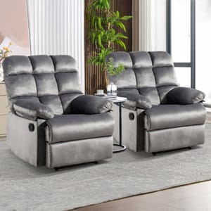 Two plush gray recliners with pillow-top armrests and built-in cup holders, set on a patterned rug in a well-lit room.