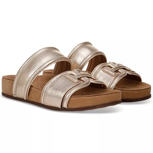 The Sam Edelman Rowan Emblem Footbed Sandals feature a metallic gold finish with two straps, an emblem design on the front strap, and a cushioned footbed for comfort. They have a slight platform sole with a casual, stylish look.