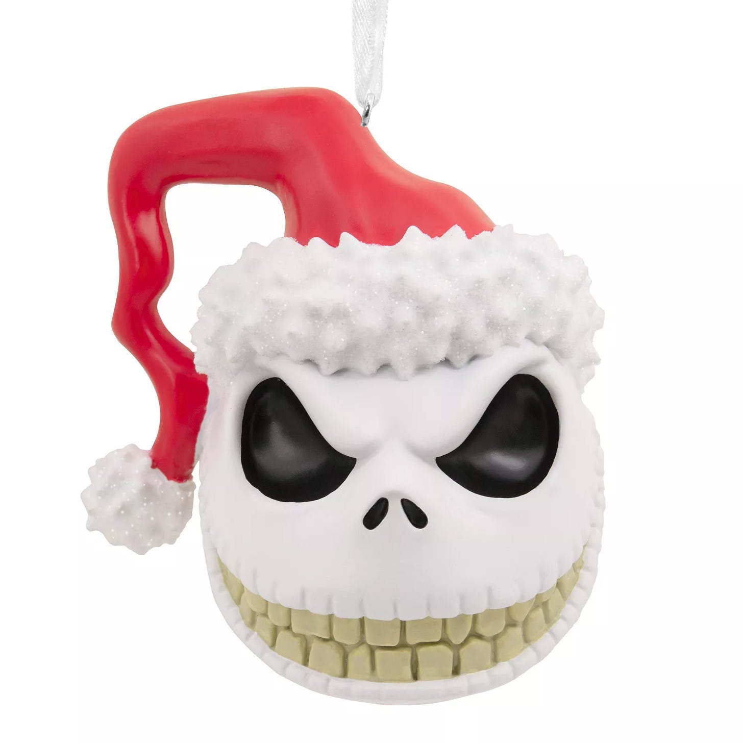 A Christmas ornament depicting a skull with a red Santa hat, featuring prominent black eyes and a wide grin.