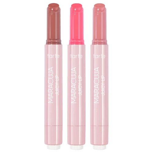 A set of three Tarte Maracuja Juicy Lip Balms in pink twist-up tubes, featuring shades of brown, bright pink, and mauve. The packaging is sleek and labeled with the brand and product name.