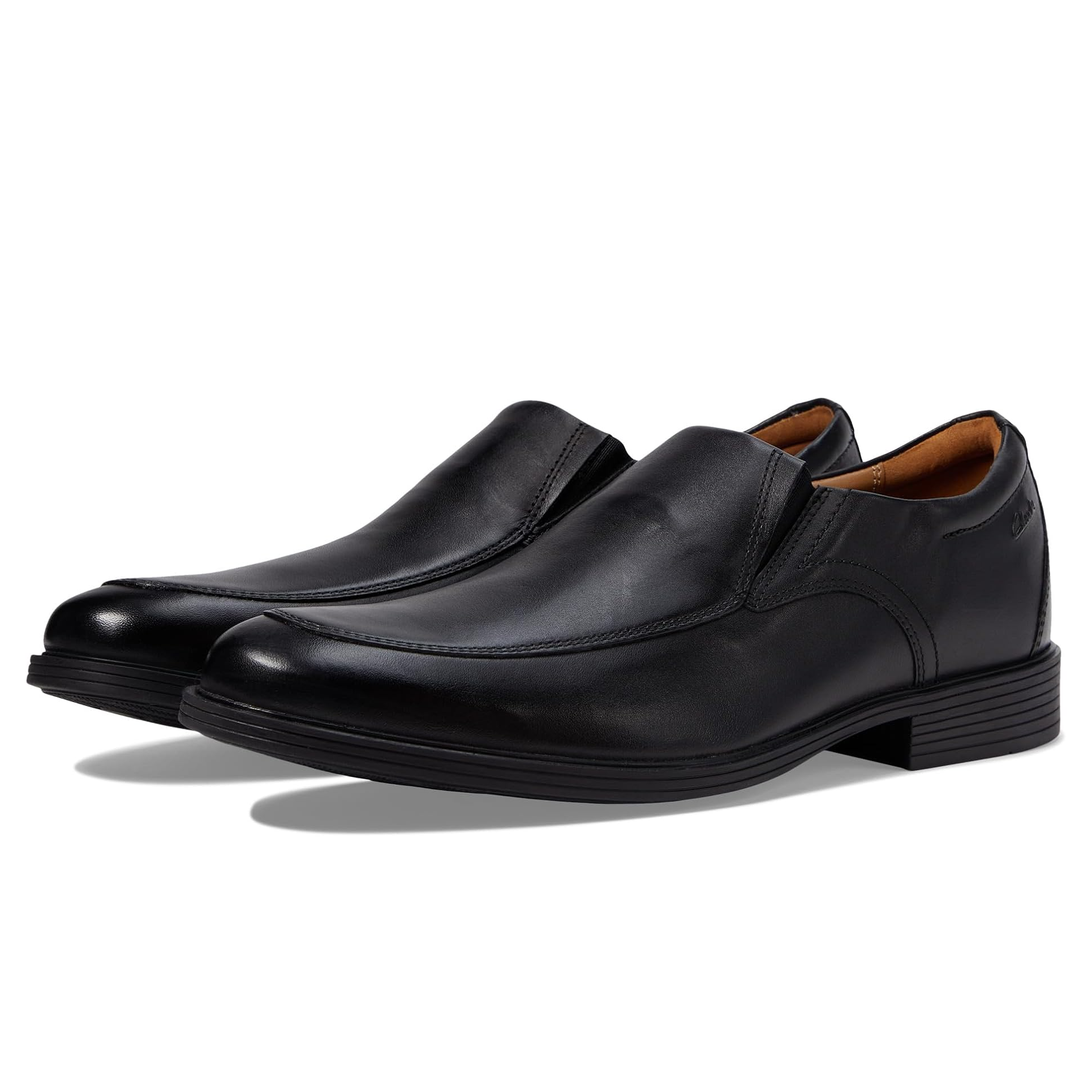 A pair of black leather slip-on dress shoes with a low block heel.