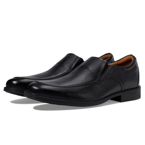 A pair of black leather slip-on dress shoes with a low block heel.