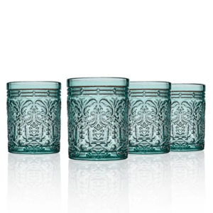 A set of four ornate, textured aqua-blue glass tumblers with intricate decorative patterns and a reflective base.