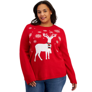 A woman is wearing a red holiday-themed sweater featuring a white reindeer pattern and decorative snowflakes.
