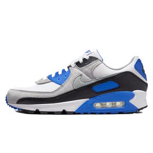 Nike Men's Air Max 90 Shoes feature a classic design with a mix of grey, blue, and black colors, including a visible Air unit in the heel and a padded collar for comfort.