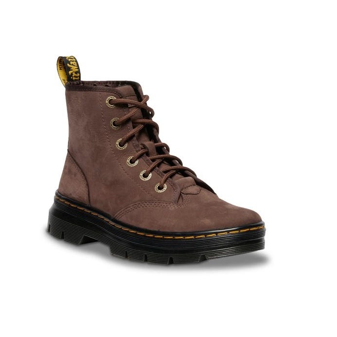 A brown lace-up boot with a thick black sole and yellow stitching, featuring metal eyelets and a branded pull tab at the back.