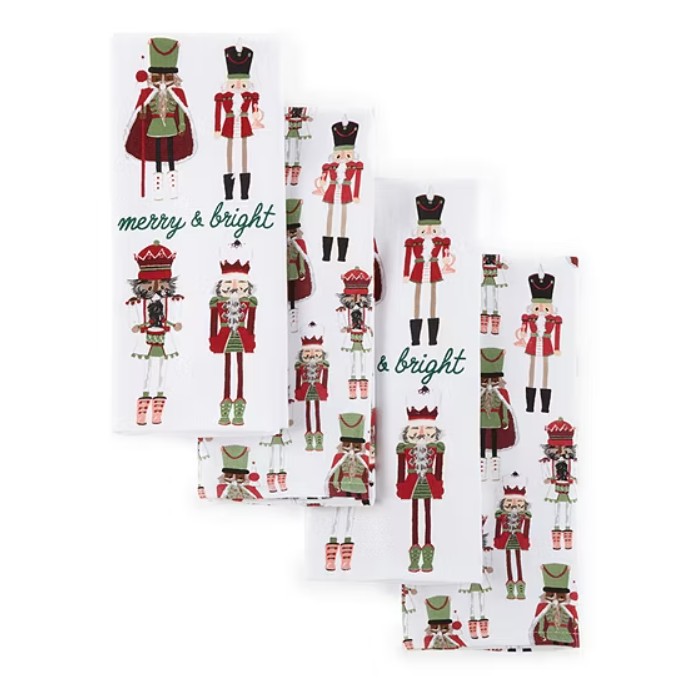 4-piece kitchen towel set featuring nutcracker designs in festive colors with \“merry & bright\“ text. Each towel showcases different nutcracker illustrations on a white background, creating a holiday-themed decor.