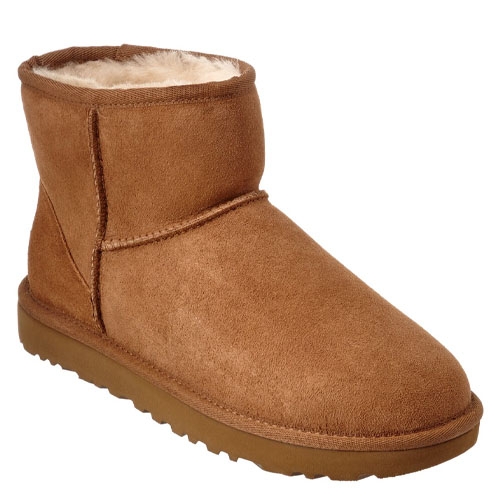 A brown, ankle-high shearling boot with a soft, rounded toe and flat sole.