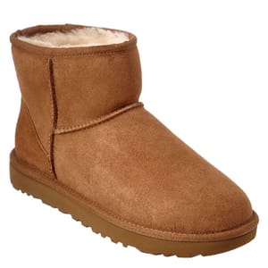 A brown, ankle-high shearling boot with a soft, rounded toe and flat sole.