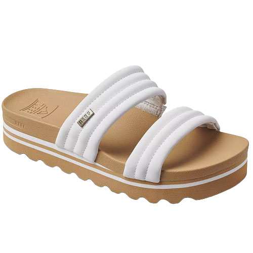 White slide sandal featuring three padded straps and a brown platform sole with a wavy tread design.