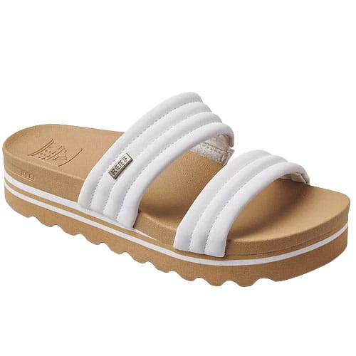 White slide sandal featuring three padded straps and a brown platform sole with a wavy tread design.