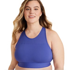 A woman wearing a blue high-neck sports bra designed for support and comfort.