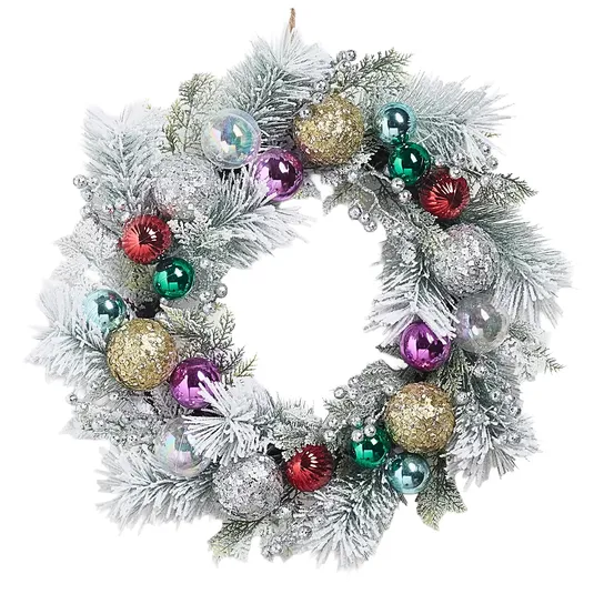A decorative Christmas wreath featuring frosted pine branches, gold and silver glittery balls, and colorful ornaments in red, green, purple, and blue, accented with shimmering silver berries.