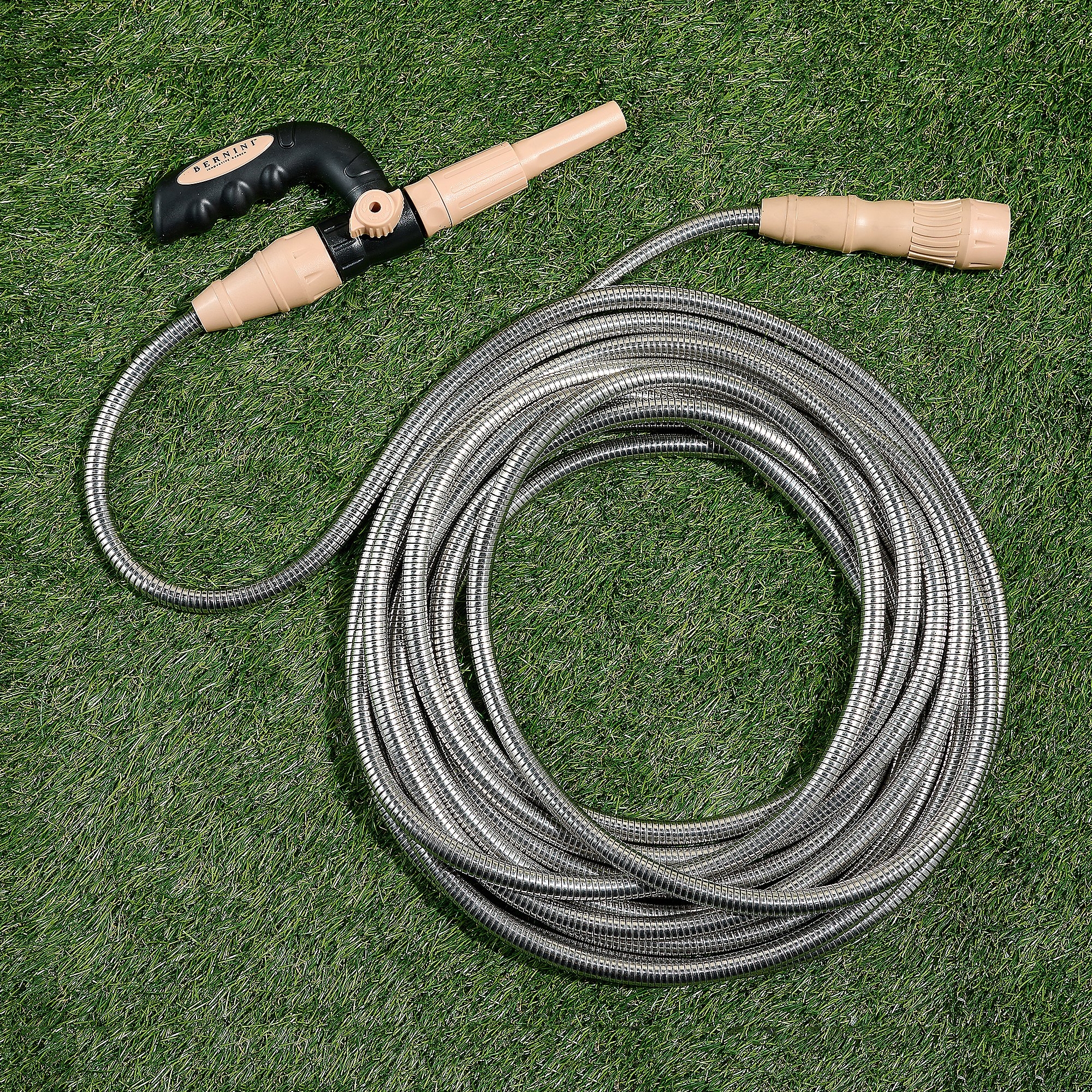 50' expandable metal hose with a durable coiled design, beige nozzle, and black handle for easy grip, suitable for various watering needs on grass or garden areas.